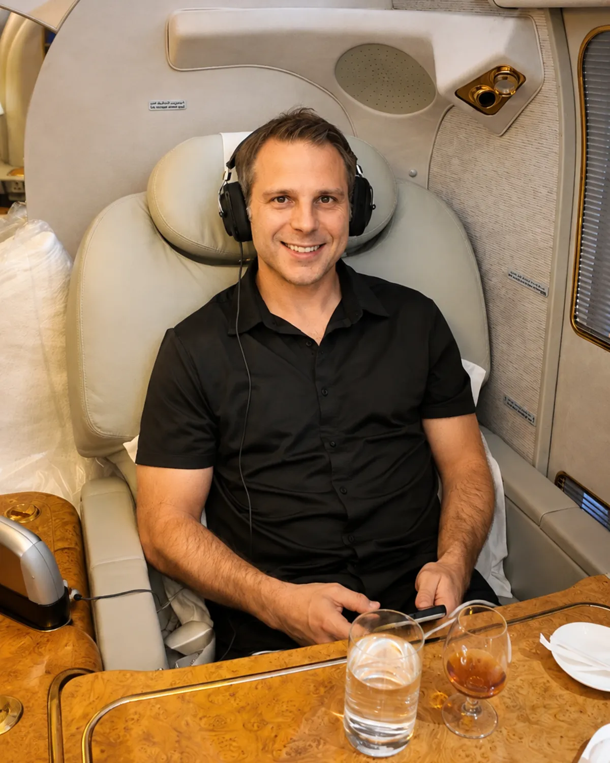 Chet Carter, founder and private travel advisor, seated in a business class suite