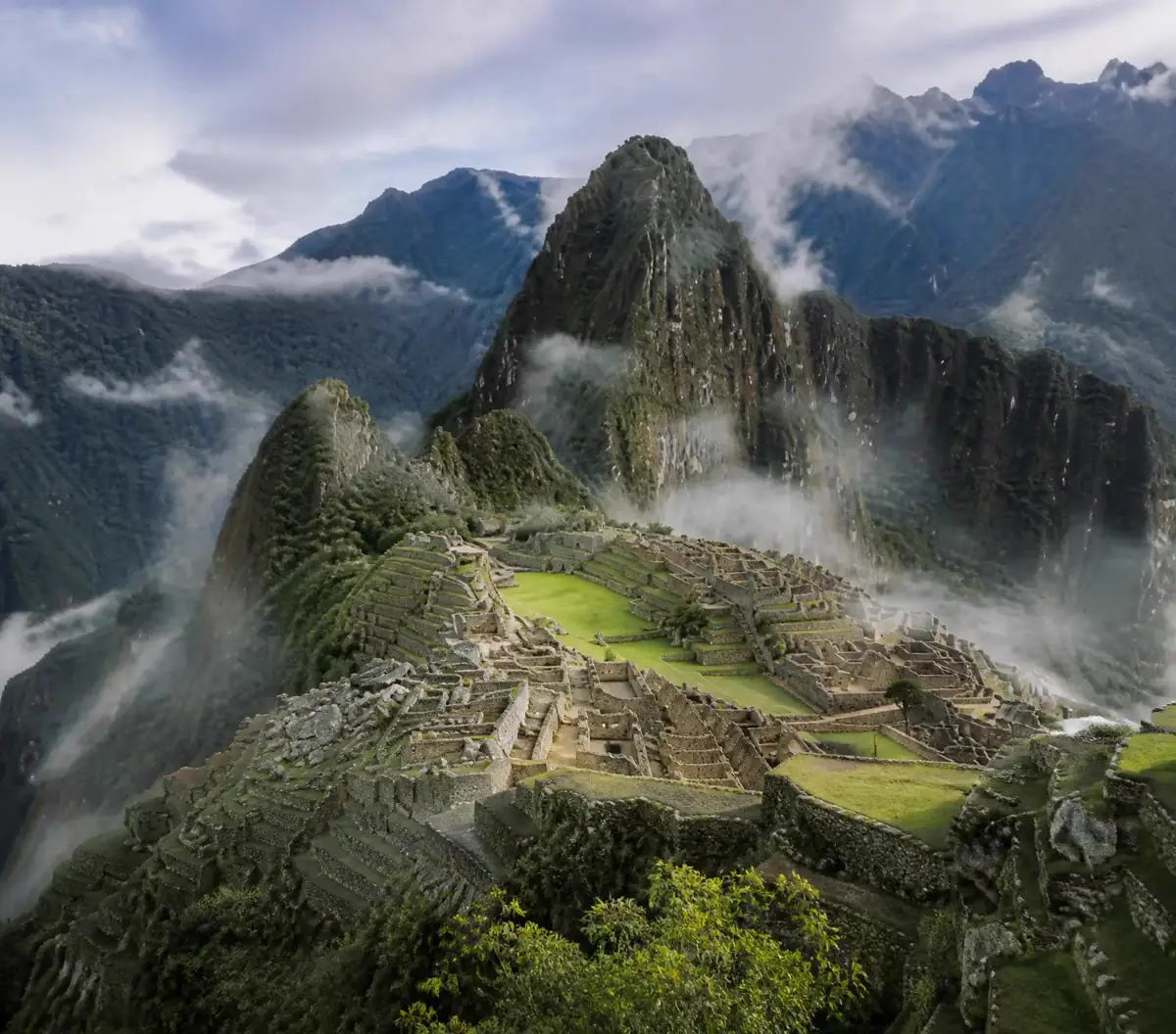 Machu Picchu shrouded in morning mist in the Peruvian Andes